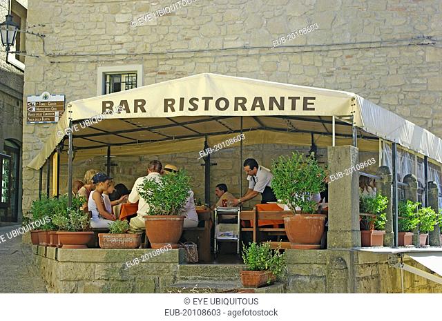 Tourists sat in outdoor restaurant
