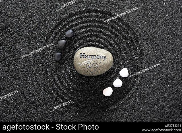 Japanese Zen garden with yin and yang stones and harmony in textured sand
