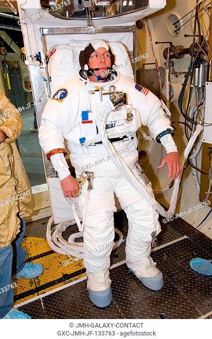 Astronaut Michael E. Fossum, STS-121 mission specialist, participates in an Extravehicular Mobility Unit (EMU) spacesuit fit check in Chamber B of the Space...