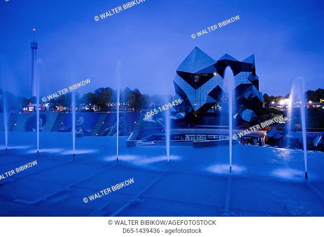 France, Poitou-Charentes Region, Vienne Department, Poitiers, Futuroscope Science Park, IMAX theater and fountains, evening