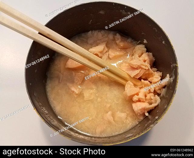 open can of canned white meat chicken in broth with chopsticks