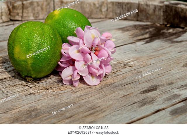 Raw textured wood Background backdrop with lemon and lime and copy space outdoor