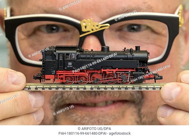 Company owner René Wilfer showing a BR 82 model of a steam locomotive (size N) on a rail track in Sonneberg, Germany, 16 January 2018
