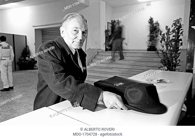 Mario Ferrari Aggradi posing his wool hat and his leather briefcase on a desk. The former Minister of the Republic Mario Ferrari Aggradi