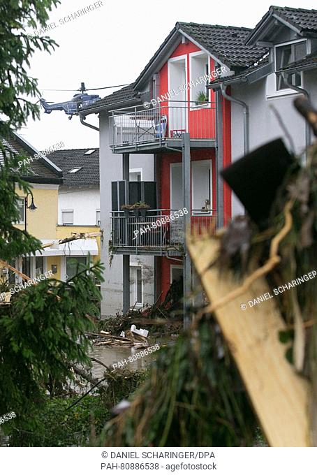 A helicoptor circles above the town center where debris is piled meters high in Simbach am Inn, Germany, 01 June 2016. After sustained rainfall a section of the...
