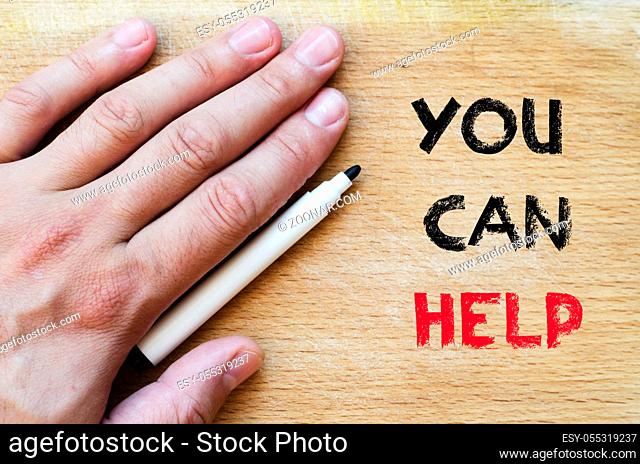 Human hand over wooden background and you can help text concept