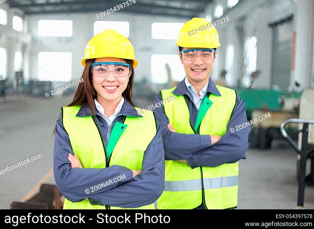 young chinese man and woman work in motor manufacturing factory