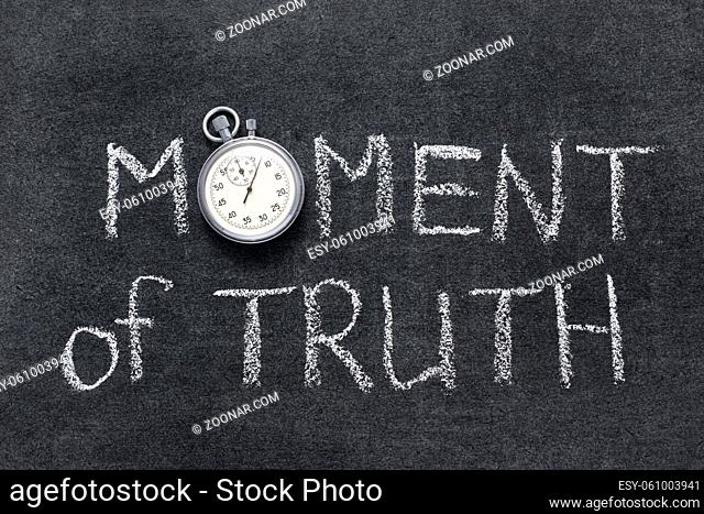 moment of truth phrase handwritten on chalkboard with vintage precise stopwatch used instead of O