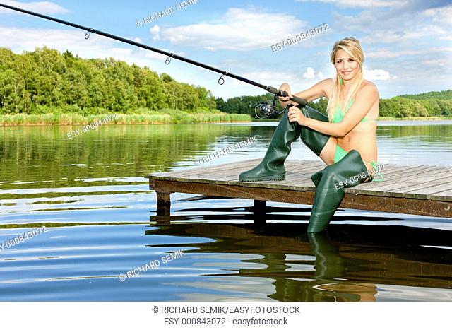 fishing woman sitting on pier