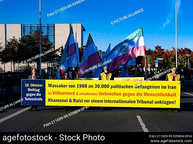 09 October 2021, Berlin: Numerous supporters of the National Council of Resistance of Iran demonstrate against the government in Iran in front of the...