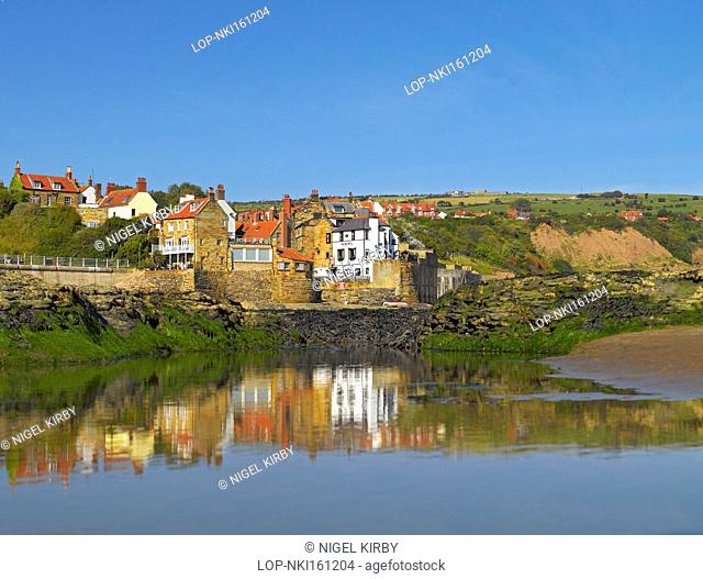 England, North Yorkshire, Robin Hoods Bay. Reflections in a pool of water on the beach at Robin Hoods Bay, the busiest smuggling community on the Yorkshire...