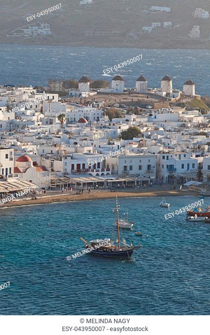 panoramic view of the Mykonos town harbor with famous windmills from the above hills on a sunny summer day, Mykonos, Cyclades, Greece