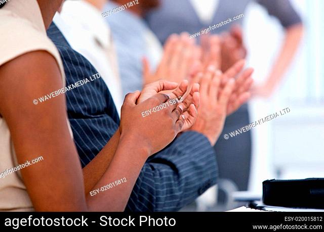 Ambitious business team applauding in a meeting