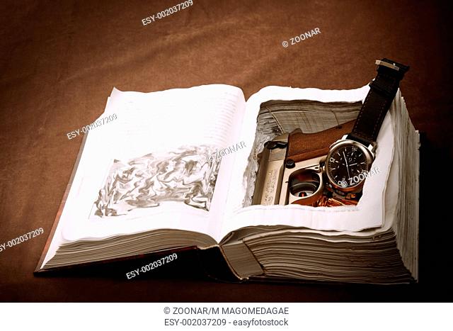 Wristwatch and gun in book safe