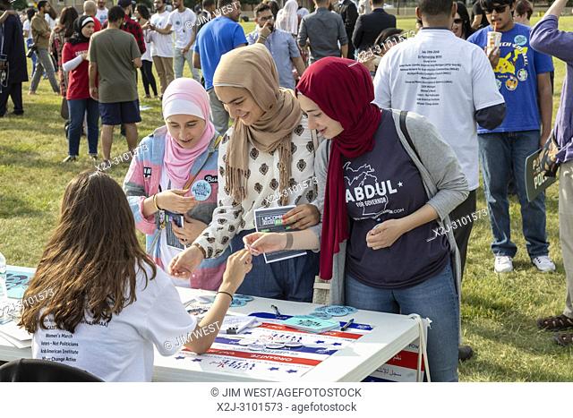 Dearborn, Michigan USA - 29 July 2018 - Women pick up literature at a Muslim Get Out the Vote rally, sponsored by several Muslim community organizations