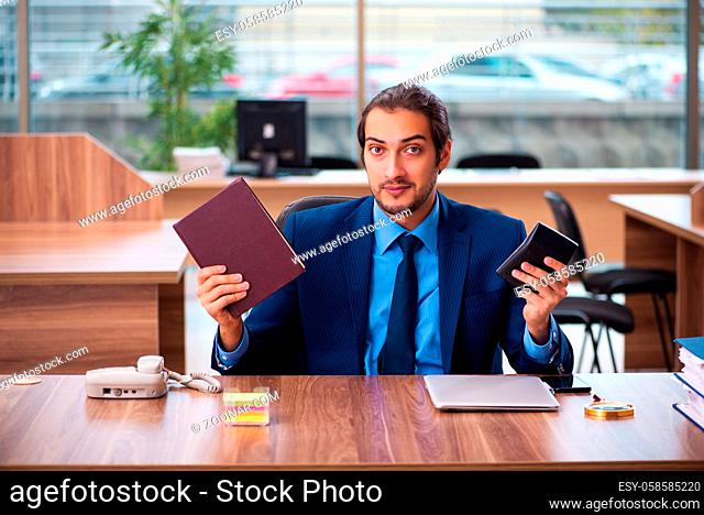Young employee reading book in the office