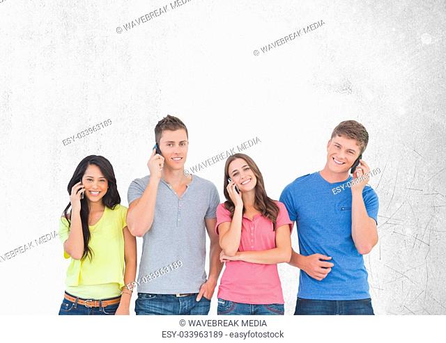 Group of friends talking on phones in front of blank grey background