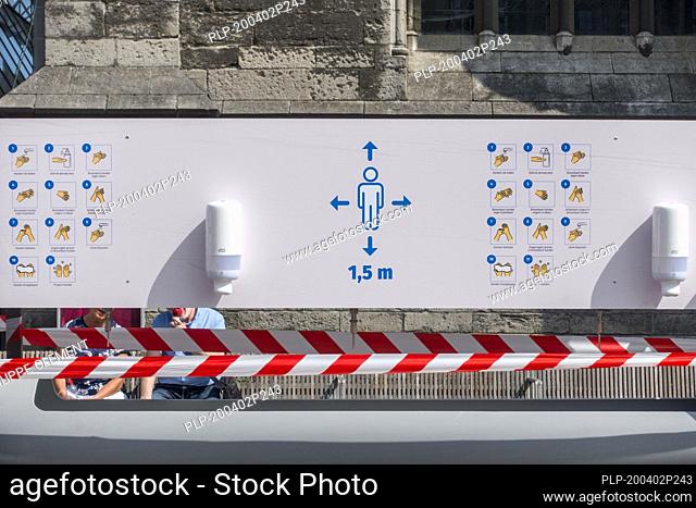 Instructions at hand washing station in shopping street during the 2020 COVID-19 / coronavirus / corona virus pandemic in the city Ghent, Belgium