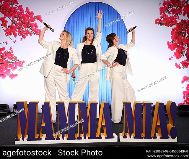 29 June 2022, Hamburg: Musical actresses Jennifer van Brenk (Tanja), Anna Thoren (Donna, alternating) and Franziska Lessing (Rosie) stand on a show stage during...