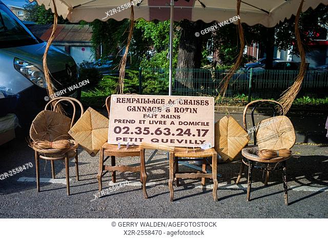 A typical chair repairers stall in the Sunday market of the small village of Darnetal near Rouen in France