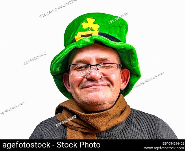 St. Patrick in a green top hat with clover. St.Patrick 's Day. Background image. Place for text. Male model