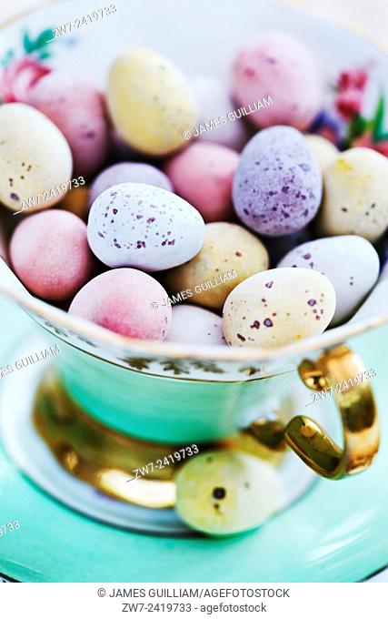 Candy coated chocolate easter eggs in antique china tea cup