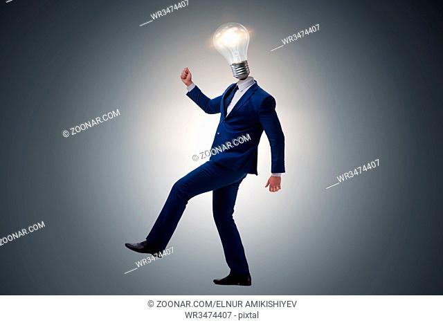 Businessman in bright idea concept with lightbulb head