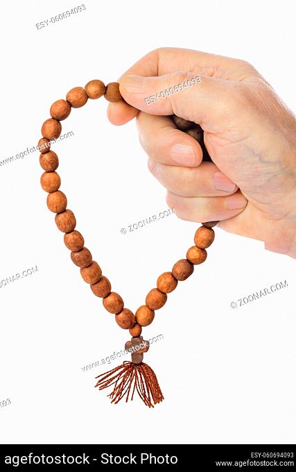 Hand with prayer beads isolated on white background