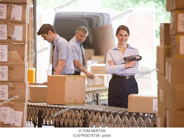 Woman holding scanner in shipping warehouse