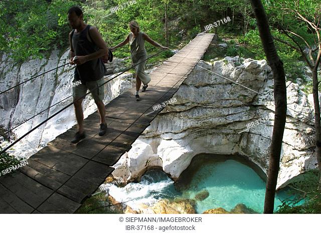Suspension bridge over the river Soca near the town of Krsovec - Julian Alps - Trenta - Slovenia