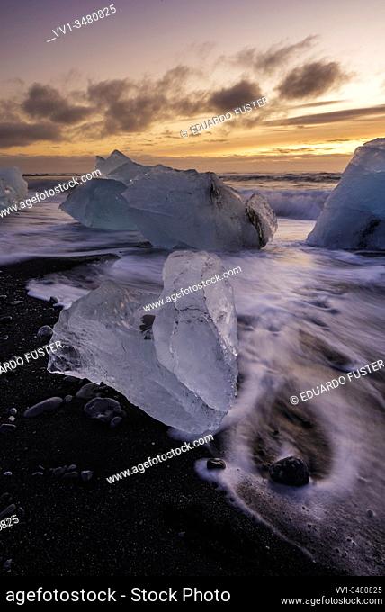 Broken ice from washed up Icebergs on Jokulsarlon black beach at sunset Jokulsarlon South east Iceland