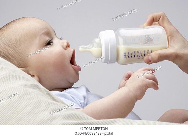 A baby being fed a bottle