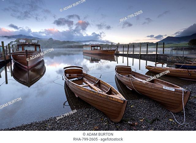Boats moored on Derwent Water at dawn in autumn, Keswick, Lake District, Cumbria, England, United Kingdom, Europe