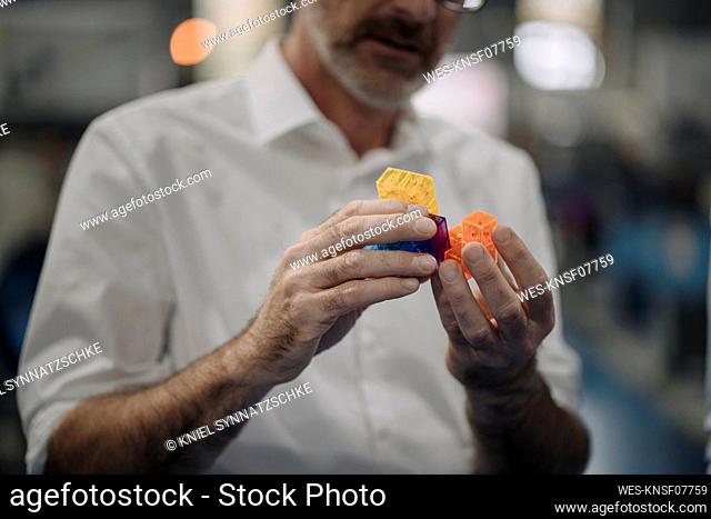 Man examining workpiece in a factory