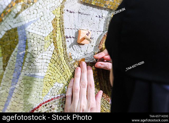RUSSIA, YEKATERINBURG - DECEMBER 13, 2023: A nun assembles a large Nativity at a mosaic workshop of Alexander Nevsky Novo-Tikhvinsky Convent