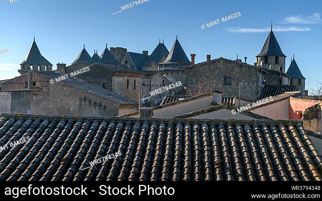 The skyline of the citadel, Château Comtal and medieval buildings with pointed roofs in the Cité of Carcassonne, tall towers and wall