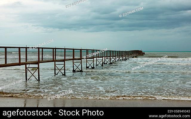 Minimalist seascape with the sea and perspective of long pier