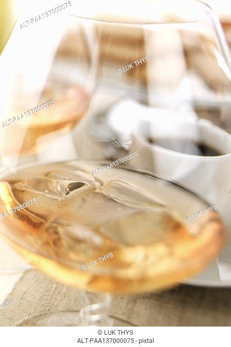 Glass of Cognac with ice cubes, close-up