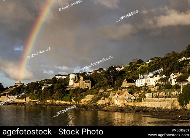 Cloudy sky with rainbow over Saint Mawes, Cornwall, UK
