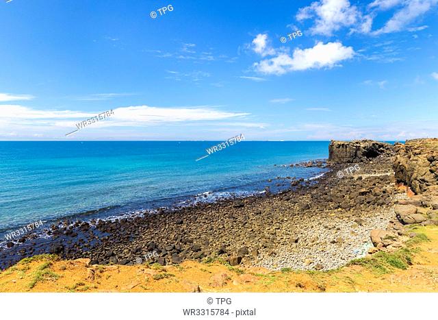 Blue ocean and sky with white cloud beside the coast;hale Cave;Xiaomenyu;Penghu;Taiwan