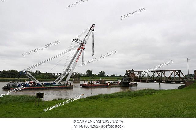 A floating crane approaches the Friesenbruecke bridge that was damaged in a collision, in Weener, Germany, 08 June 2016. Half a year after the bridge was...