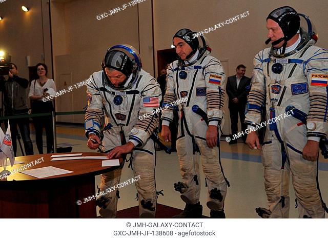 At the Gagarin Cosmonaut Training Center in Star City, Russia, Expedition 3940 Flight Engineer Steve Swanson of NASA (left) signs in for qualification exams...