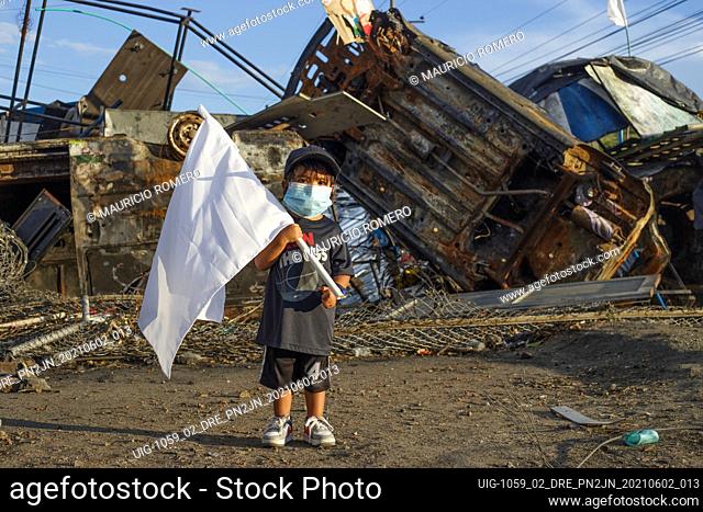 A young kid stands with a white peace flag as demonstrations against the government of president Ivan Duque rise admist police brutality and unrest that...