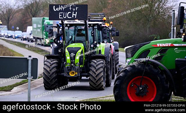 18 December 2023, Lower Saxony, Uelzen: ""Wir für Euch"" (We for you) is written on a tractor driving at walking pace along the Bundesstraße 4