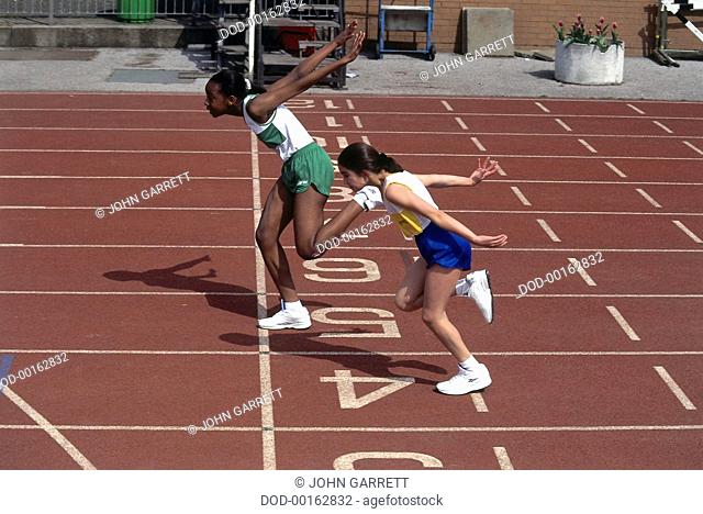 Two Girls Finishing a Race, at Finishing Line on Track