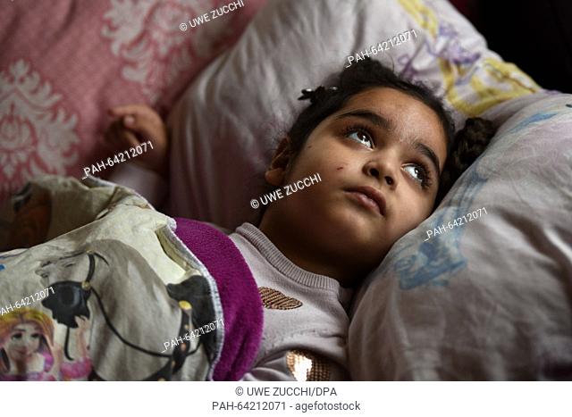 Aliana lies in her bed in Bad Hersfeld, Germany, 2 December 2015. Five-year old Aliana is chronically ill with the incurable measles disease encephalitis SSPE
