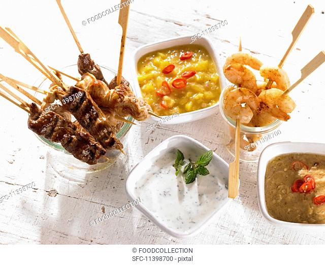 Meat, poultry and prawn skewers with dips