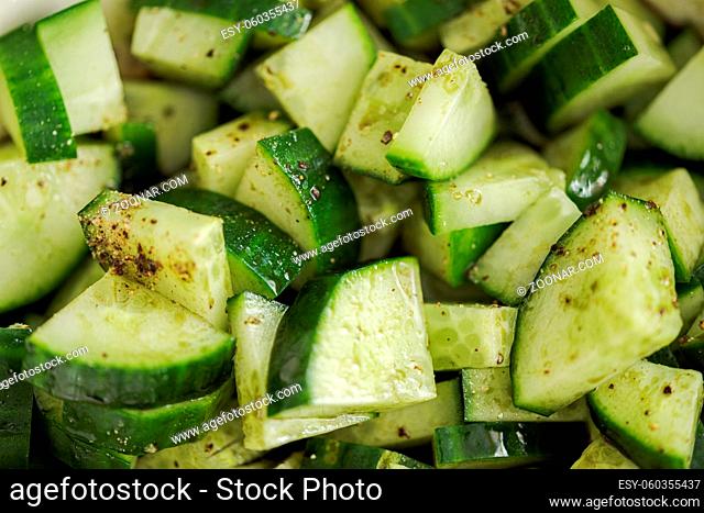 Close up flat lay of slices of homegrown salad cucumber cut into quadrants