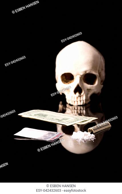 cocaine, Herion or other illegal drugs that are sniffed by means of a tube or injected with a syringe, money and Skull, isolated on black glossy background