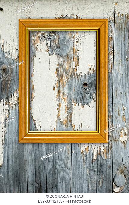 Gold frame on a old wooden wall background